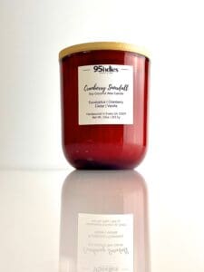 Cranberry Snowfall soy coconut wax candle by 95indies in a red glass jar with a wooden lid, featuring eucalyptus, cranberry, cedar, and vanilla fragrance. Hand-poured by a small business in Evans, Georgia.
