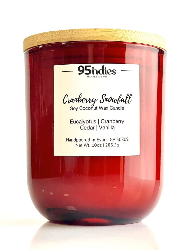 Cranberry Snowfall soy coconut wax candle by 95indies in a red glass jar with a wooden lid, featuring eucalyptus, cranberry, cedar, and vanilla fragrance. Hand-poured by a small business in Evans, Georgia.
