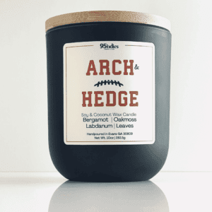 Arch & Hedge 10oz soy and coconut wax candle with matte black jar, bamboo lid, and rich fragrance notes of bergamot, oakmoss, labdanum, and leaves.