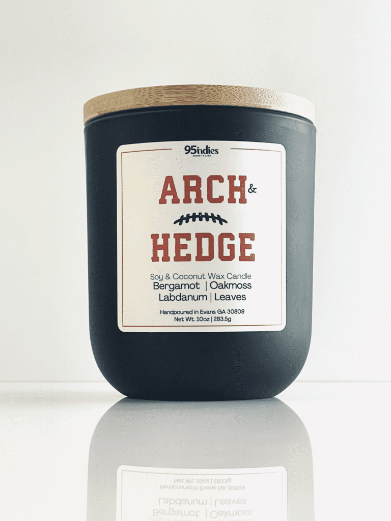Arch & Hedge 10oz soy and coconut wax candle with matte black jar, bamboo lid, and rich fragrance notes of bergamot, oakmoss, labdanum, and leaves.