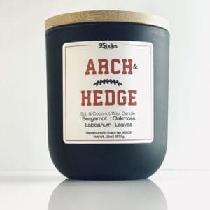 Arch & Hedge 10oz soy and coconut wax candle with matte black jar, bamboo lid, and rich fragrance notes of bergamot, oakmoss, labdanum, and leaves.