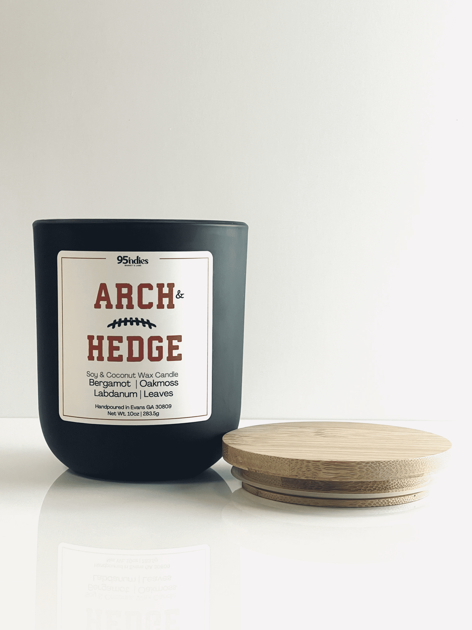 Arch & Hedge 10oz Artisan Candle – Perfect for game days, tailgating, and elegant evenings at home. Arch & Hedge 10oz soy and coconut wax candle with matte black jar, bamboo lid, and rich fragrance notes of bergamot, oakmoss, labdanum, and leaves.