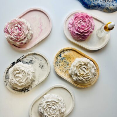 Handmade Jesmonite trays with floral toppers in assorted colors, perfect for Mother's Day gifting.