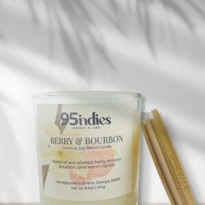 Ivory Berry & Bourbon candle on soft wood with vanilla blossom label and natural shadowing