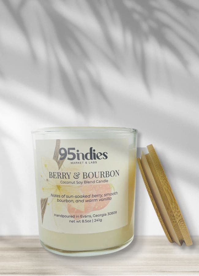 Ivory Berry & Bourbon candle on soft wood with vanilla blossom label and natural shadowing