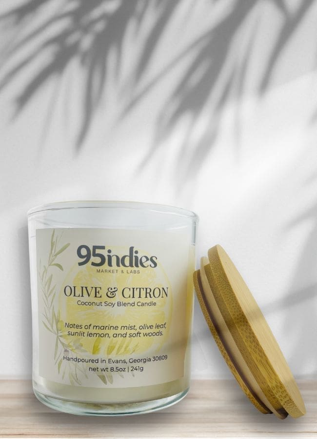 Ivory Olive & Citron candle with bamboo lid, soft palm shadows, and citron-toned label complete with olive leaves