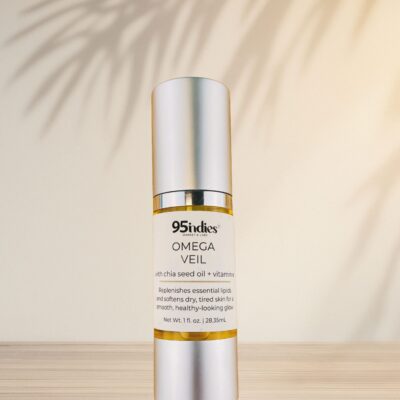 Omega Veil oil bottle by 95indies with warm palm leaf shadows in background