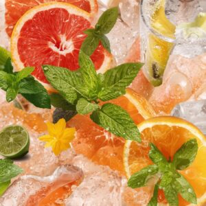 Fresh grapefruit slices, lime wedges, and mint leaves layered over crushed ice with citrus peel and bright natural light