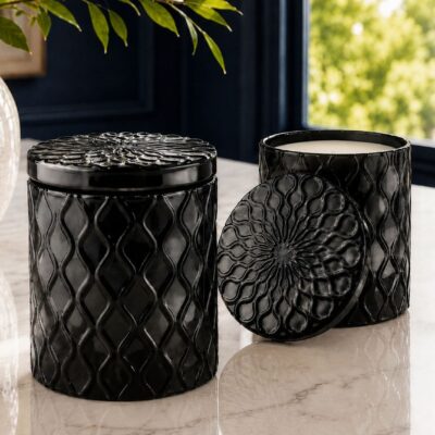 Black sculpted wickless candle in decorative reusable glass vessel with matching embossed lid by 95indies
