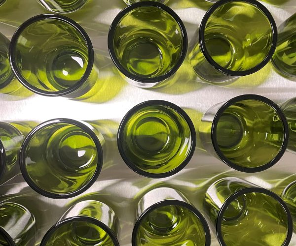 Vibrant green glass jars for hand-poured soy coconut wax candles by 95indies, showcasing artisanal craftsmanship and timeless elegance.